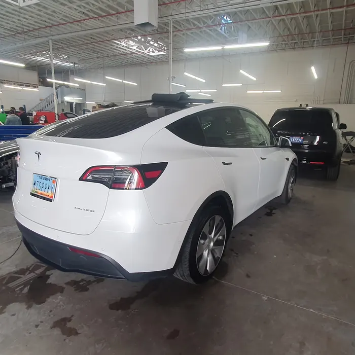 Customer photo of a Tesla Model Y in the Updated Auto Body shop